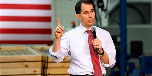 FILE - In this Aug. 18, 2015 file photo, Republican presidential candidate, Wisconsin Gov. Scott Walker, speaks in Brooklyn Center, Minn., where he presented his plan to replacing President Barack Obama's health care law. (AP Photo/Jim Mone, File)