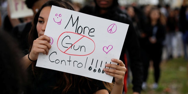 Students from South Plantation High School carrying placards and shouting slogans walk on the street during a protest in support of the gun control, Feb. 21, 2018.