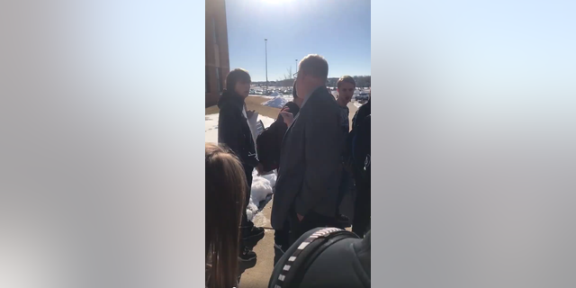 School Principal Lonnie Seifert is seen approaching a student carrying a pro-Second Amendment sign.