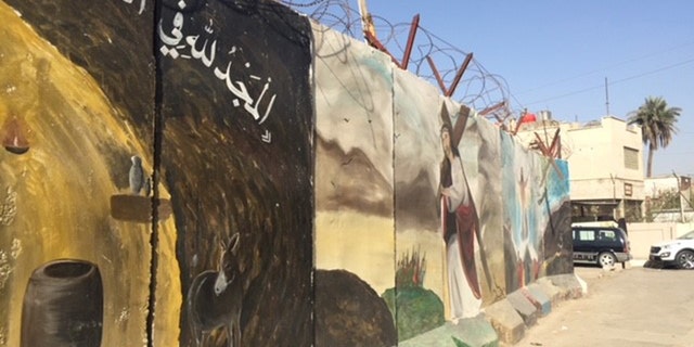 A wall protects Our Lady of Deliverance Church in Baghdad from attack.