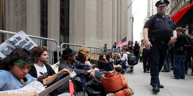 Sept. 17: Demonstrators gather in front of a police barricade to call for the occupation of Wall Street in New York.