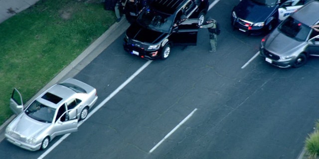Police surrounded a vehicle being driven they say by a man wanted in the shooting death of a woman Thursday in Walnut Creek, Calif.
