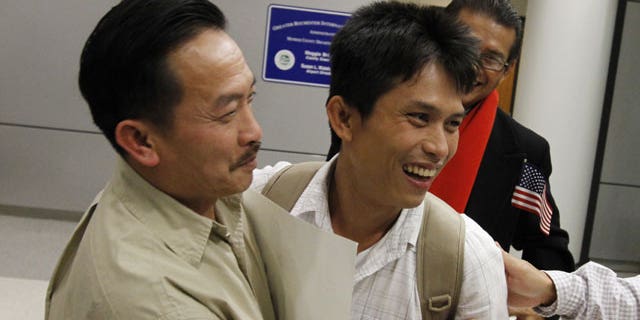 November 21, 2011: Hao Truong, Henrietta, left, embraces his son, Samart Khumkhaw, 34, during his emotion filled arrival at the Greater Rochester International Airport in Chili, N.Y.