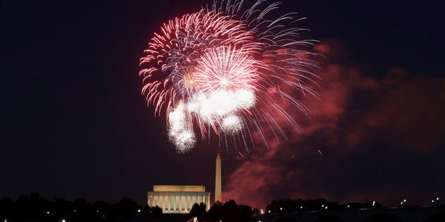 Fireworks explode over the Lincoln and Washington Monuments as Independence Day is celebrated in Washington, D.C.