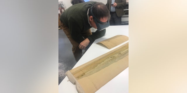 Scott Stephenson examines the watercolor (Courtesy of the Museum of the American Revolution)