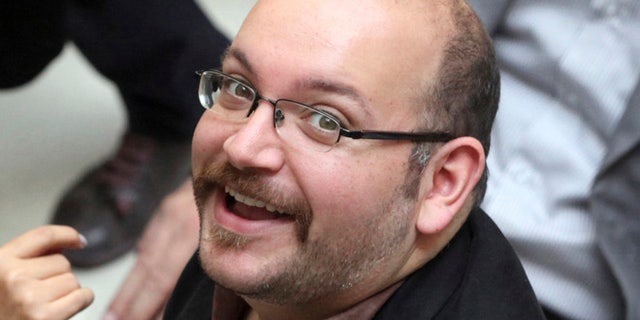 FILE 2013: Jason Rezaian, an Iranian-American correspondent for the Washington Post, smiles as he attends a presidential campaign of President Hassan Rouhani in Tehran.