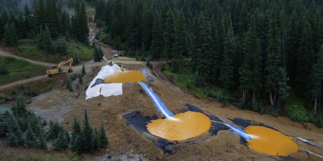 Aug. 12, 2015: Water flows through a series of retention ponds built to contain and filter out heavy metals and chemicals from the Gold King mine chemical accident, in the spillway about 1/4 mile downstream from the mine, outside Silverton, Colo. (AP)