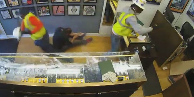 Surveillance video caught store owner Kyle O'Connor scaring intruders out of his store after he pulled out a gun.