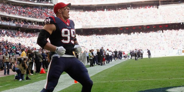 HOUSTON, TX - NOVEMBER 30: J.J. Watt #99 of the Houston Texans gets the crowd going before the opening kickoff against the Tennessee Titans at NRG Stadium on November 30, 2014 in Houston, Texas. (Photo by Bob Levey/Getty Images)