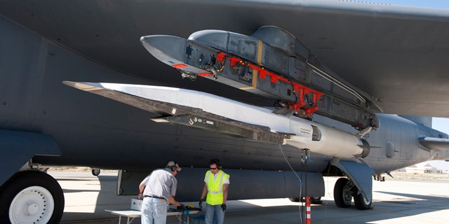 Ground crew members make the final checks to the X-51A Waverider scramjet, which is affixed to an Edwards B-52H Stratofortress, before the Waverider's June 13 flight test.
