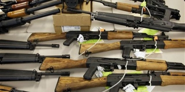 FILE: Jan. 25, 2011: Part of a cache of seized weapons displayed at a news conference in Phoenix.