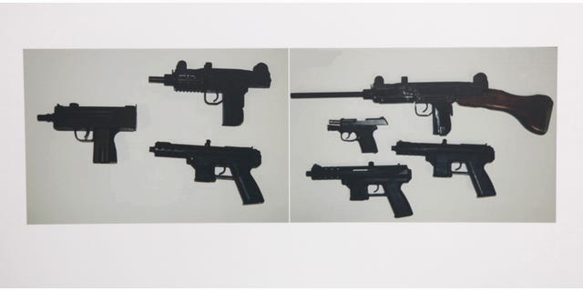 June 1, 2012: Photographs showing some of guns confiscated during the investigation of alleged illegal gun sales by two Sacramento County Sheriff's deputies are seen at a news conference in Sacramento, Calif.