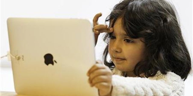 A girl views a new iPad tablet computer at an Apple store during its UK launch in central London May 28, 2010.