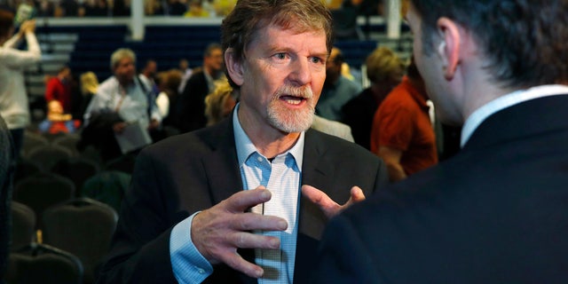 Jack Phillips, owner of Masterpiece Cake, speaks to supporters after a rally on the campus of a Christian college in Lakewood, Colo.