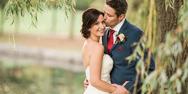 Brittany and Clayton Cook were being photographed after their wedding when Clayton noticed a boy in the water struggling to swim