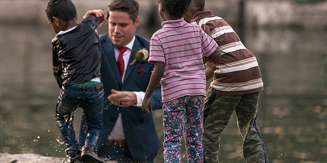 A groom in Canada is being called a hero after he saved a little boy from drowning during his wedding photo shoot