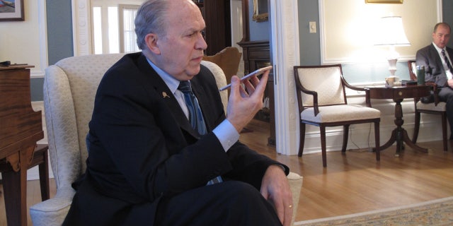 Alaska Gov. Bill Walker speaks by phone to a reporter not physically present for a media availability at the governor's mansion in Juneau, Alaska.