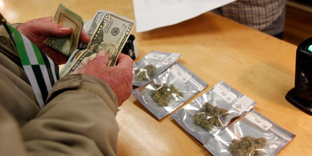 Jan. 1, 2018: A customer purchases marijuana at Harborside marijuana dispensary in Oakland, Calif.