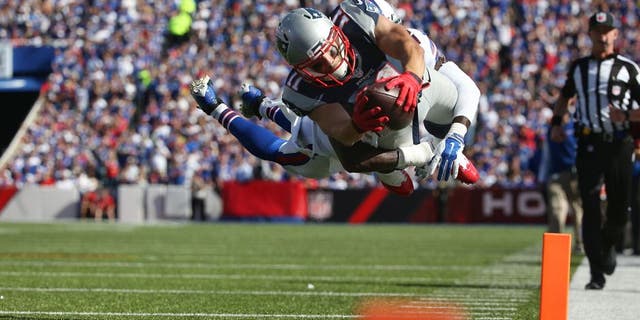ORCHARD PARK, NY - SEPTEMBER 20: Julian Edelman #11 of the New England Patriots scores a touchdown during NFL game action as Aaron Williams #23 of the Buffalo Bills tries to make the tackle at Ralph Wilson Stadium on September 20, 2015 in Orchard Park, New York. (Photo by Tom Szczerbowski/Getty Images)