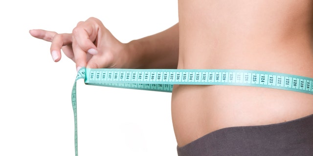 "Woman body part measuring waist, healthy lifestyle concept"