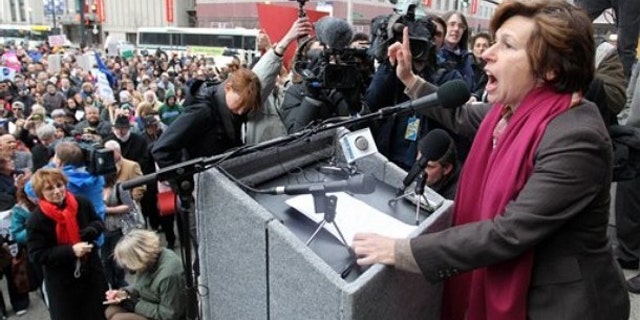 Randi Weingarten, right, president of the American Federation of Teachers, speaks to a crowd on the steps of Providence, R.I., City Hall March 2.