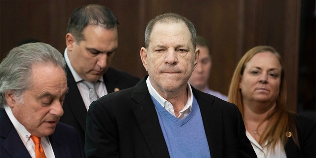 Harvey Weinstein, center, listens during a court proceeding in New York during his arraignment on rape and other charges on May 25.