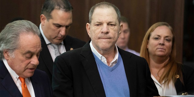 Harvey Weinstein, center, listens during a court proceeding in New York during his arraignment on rape and other charges on May 25.