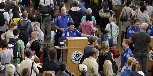 Travelers at Seattle-Tacoma International Airport wait to go through TSA security.