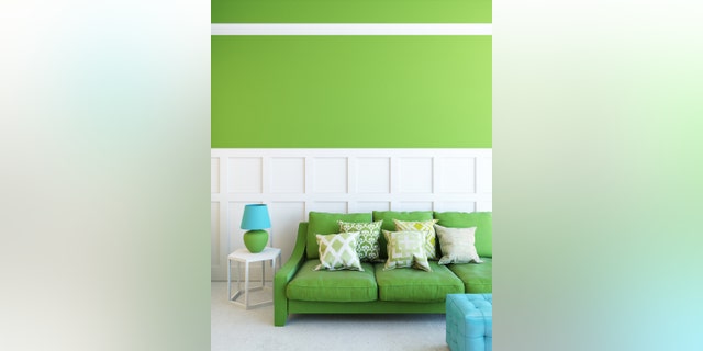 green sofa in green room with lamp