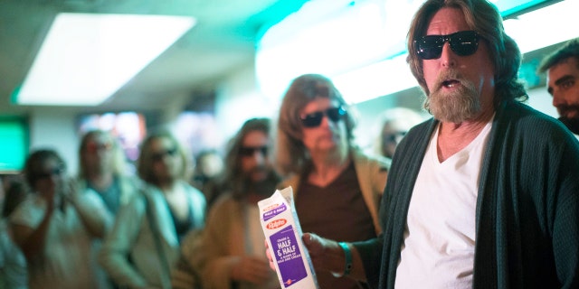 Mike Ritto (R) and other enthusiasts wear costumes resembling characters from the movie "The Big Lebowski" at the Lebowski Fest LA Bowling Party in Fountain Valley, California.