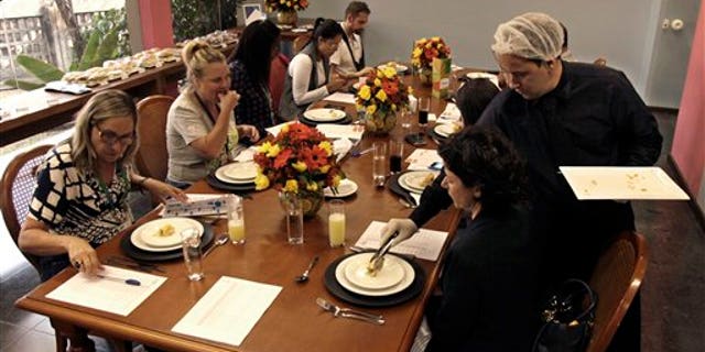 In this May 6, 2016 photo, members of the Rio Olympics food and beverage service test the Olympic menu in Rio de Janeiro, Brazil. "To assure that our ingredients are free of steroids and other kinds of chemicals, we are making sure our suppliers have all the certificates that are demanded by our national food and drug agency," said Marcello Cordeiro, Rios director of food and beverages. (AP Photo/Renato Spyrro)