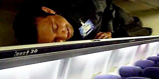 Crew members squeeze into overhead bins after passengers takeoff.