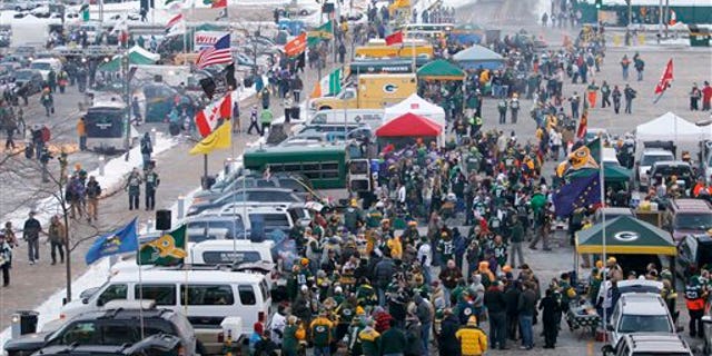 Fans tailgate at Lambeau Field before an NFL wild card playoff football game between the Green Bay Packers and the Minnesota Vikings Saturday, Jan. 5, 2013, in Green Bay, Wis. (AP Photo/Mike Roemer)