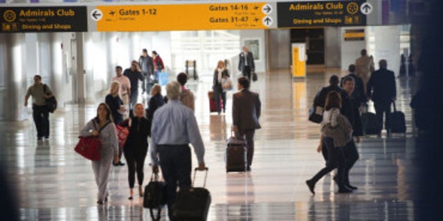 Passengers move through a JFK airport terminal.