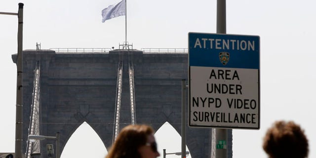 July 22, 2014: A white flag flies atop the west tower of New York's Brooklyn Bridge. The NYPD is investigating who was behind the flag switch, but one person called The Daily News claiming responsibility.