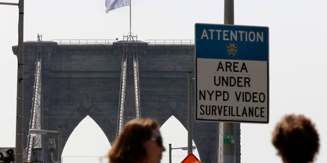 July 22, 2014: A white flag flies atop the west tower of New York's Brooklyn Bridge. The NYPD is investigating who was behind the flag switch, but one person called The Daily News claiming responsibility.