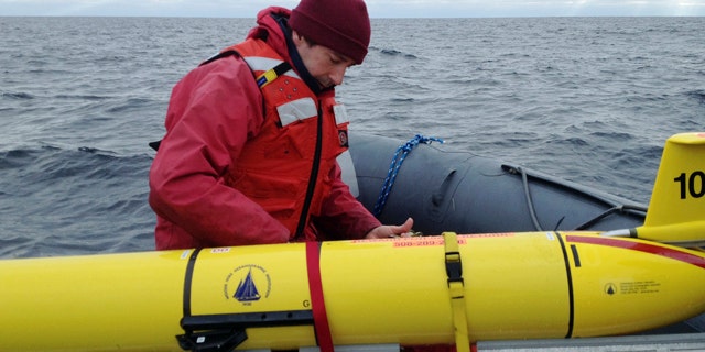 Dec. 4, 2012: Woods Hole Oceanographic Institution chief scientist Mark Baumgartner, secures an underwater robot used to collect acoustic data to help scientists locate endangered whales in the north Atlantic Ocean.