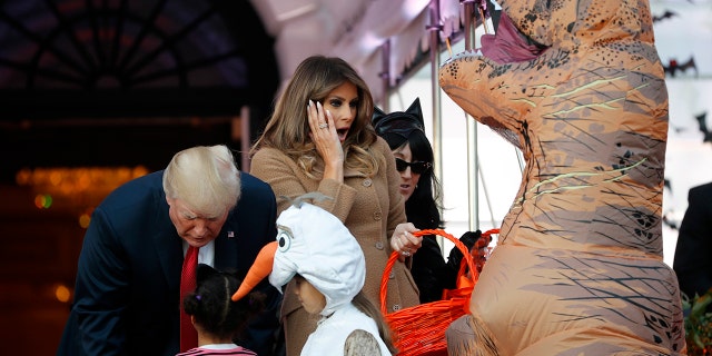 President Donald Trump and first lady Melania Trump hand out treats as they welcome children from the Washington area and children of military families to trick-or-treat celebrating Halloween at the South Lawn of the White House in Washington, Monday, Oct. 30, 2017.