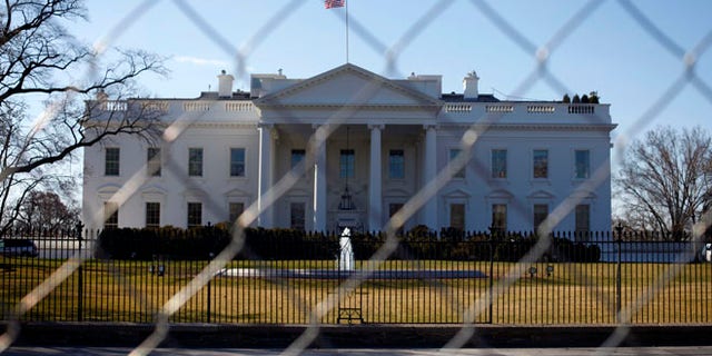 March 4, 2013: The White House is seen through a chain-link fence in Washington.