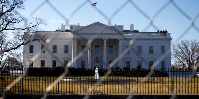 March 4, 2013: The White House is seen through a chain-link fence in Washington.