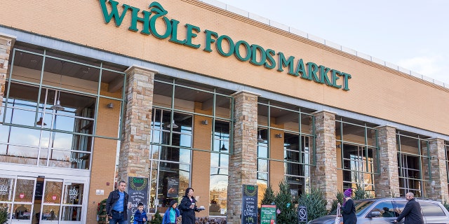 Whole Foods storefront with people outside.