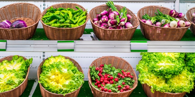 Fruits and vegetables on a supermarket shelf.