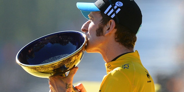 July 22, 2012: Bradley Wiggins, winner of the 2012 Tour de France cycling race kisses the trophy on the podium of the the Tour de France cycling race in Paris, France.