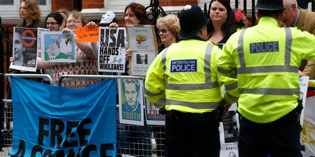June 19, 2014: Supporters of WikiLeaks founder Julian Assange hold a vigil outside the Ecuadorian Embassy in London to mark his two years in refuge at the embassy.