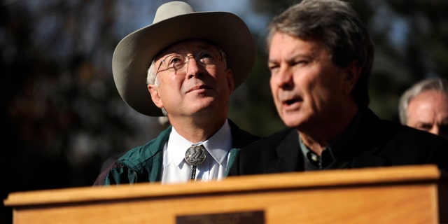 Secretary of the Interior Ken Salazar watches geese fly overhead as Bureau of Land Management Director Bob Abbey speaks about an initiative that would allow the BLM to designate and protect wilderness areas on Thursday, Dec. 23, 2010 outside of REI in Denver. (AP)
