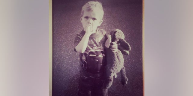 William as a young boy, holding the now-missing Eeyore.