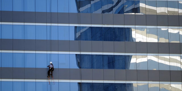 A window washer works outside a Marriott hotel near the Olympic Park before the start of the Rio 2016 Olympics in Rio de Janeiro, August 1, 2016. Picture taken August 1, 2016.