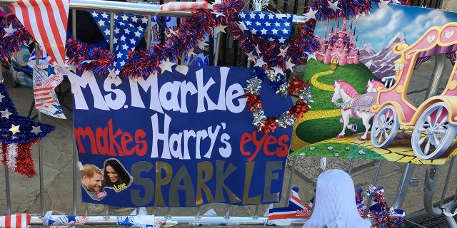 A handmade poster adorns the sidewalk and barricades outside of Windsor Castle where people are camped out ahead of the royal wedding.