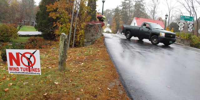 In this Tuesday, Oct. 18, 2016 photo, a yard sign opposing an industrial wind project sits at the side of the road in Grafton, Vt.