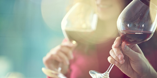 Close-up of people tasting red wine in glass